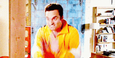 Man In Yellow Sweater By Bookshelf GIF