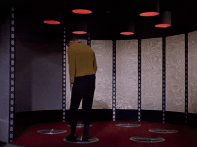 Man In Yellow Sweater In Room With Red Lights GIF