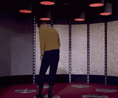 Man In Yellow Sweater Under Red Lights GIF