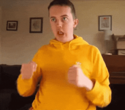 Man in Yellow Sweatshirt Making Funny Face