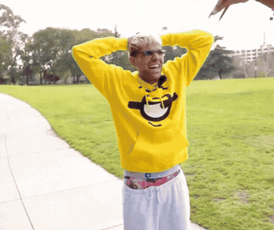 Man In Yellow Sweatshirt With Smiley Face GIF
