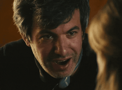 Man In Yellow Sweatshirt With Smiley Face GIF
