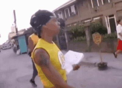 Man In Yellow Tank Top Holding Paper GIF