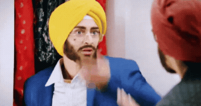 Man In Yellow Turban Talking To Another Man GIF