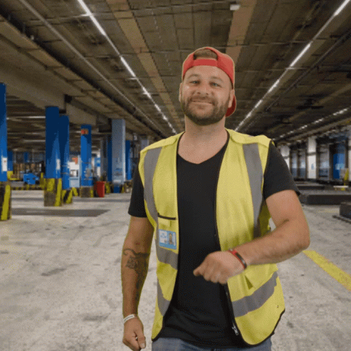 Man In Yellow Vest And Black Shirt With A.J. Name Tag GIF