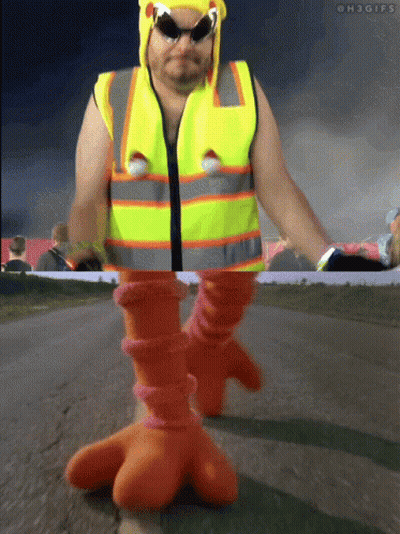 Man In Yellow Vest And Orange Boots Walking GIF