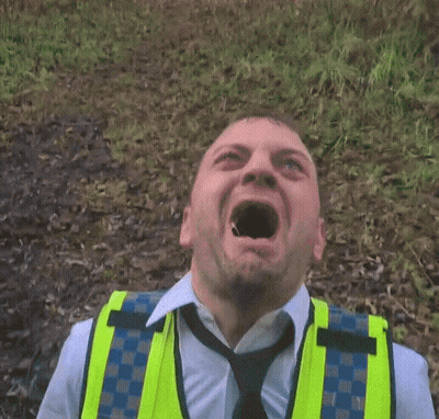 Man In Yellow Vest And Tie Making Face GIF
