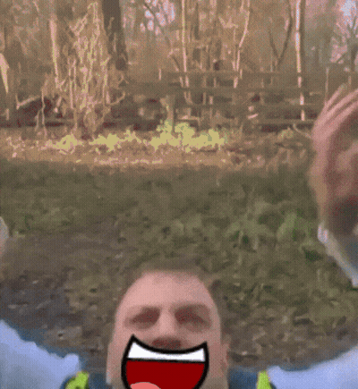 Man In Yellow Vest And Tie With Cartoon Face Drawn On Face GIF
