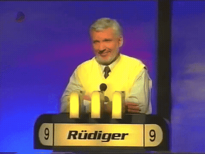 Man In Yellow Vest At Podium With Number 9 GIF