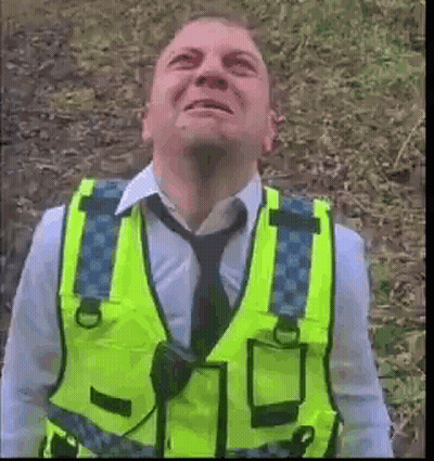 Man In Yellow Vest Looking Up At Sky GIF