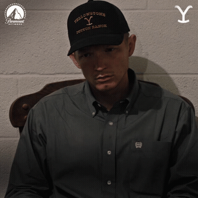 Man In Yellowstone Hat Sitting In Chair GIF