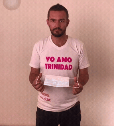 Man In Yo Amo Trinidad Shirt Holding Face Mask GIF