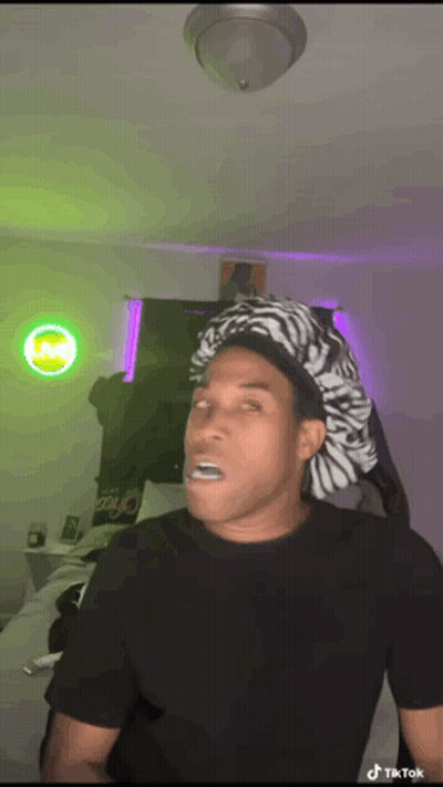 Man In Zebra Hat Making Funny Face GIF