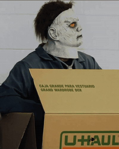 Man In Zombie Mask Holding U-Haul Box GIF