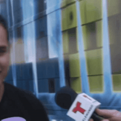 Man Interviewed By Person With Red T Microphone GIF