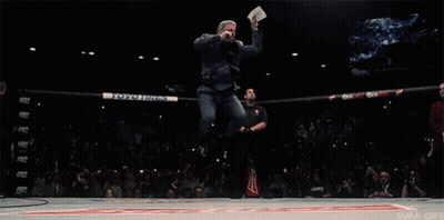 Man Jumping Holding Paper Saying UFC GIF