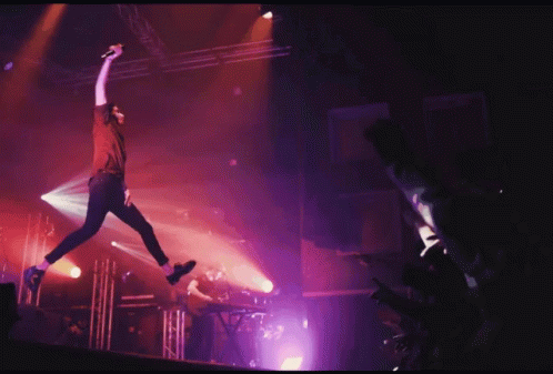 Man Jumping in Air With Microphone