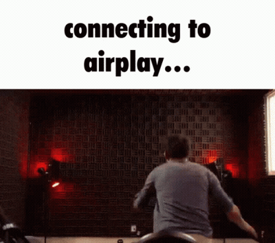 Man Jumping In Front Of Wall Saying Connecting To Airplay GIF