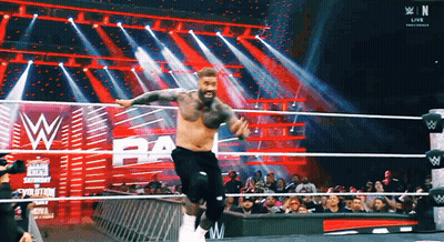 Man Jumping In Wrestling Ring With Crowd Watching GIF