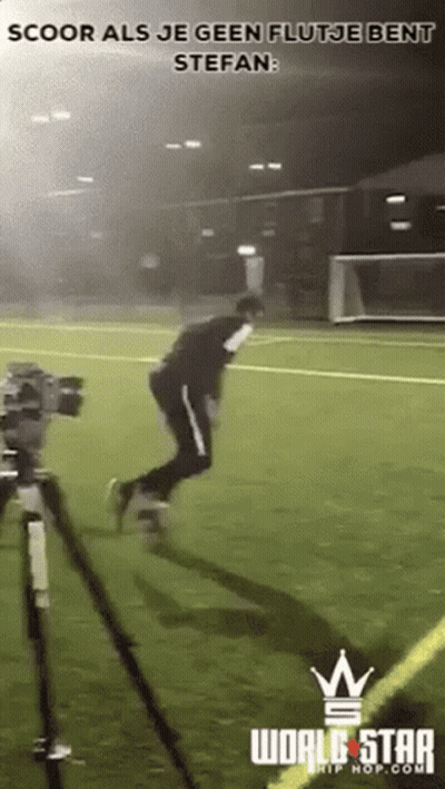 Man Jumping On Soccer Field With Camera GIF