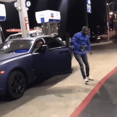 Man Jumping Out of Car at Gas Station