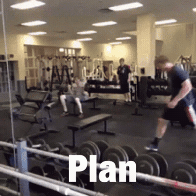 Man Jumping Over Dumbbells With Plan Written On Floor GIF