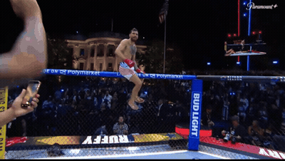 Man Jumping Over Fence With Bud Light Sign GIF