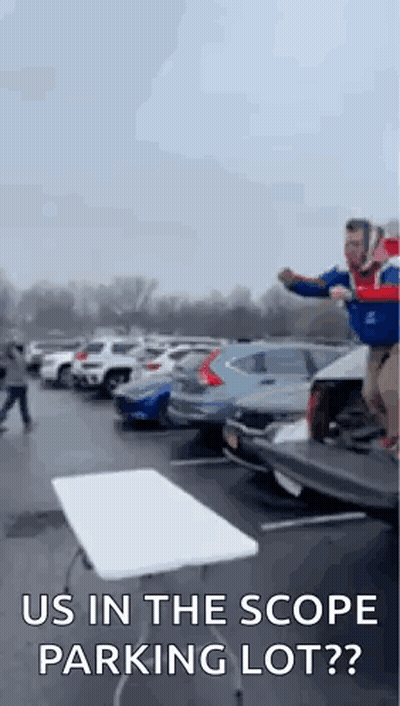 Man Jumping Over Table In Parking Lot Saying Us In The Scope Parking Lot? GIF