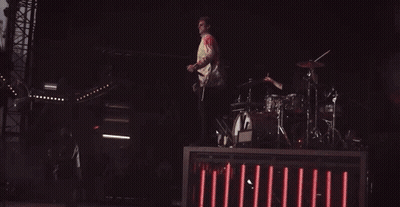 Man Jumping While Playing Drums On Stage GIF