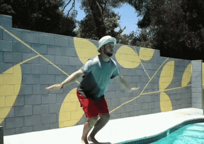 Man Jumps Into Swimming Pool With Hat GIF