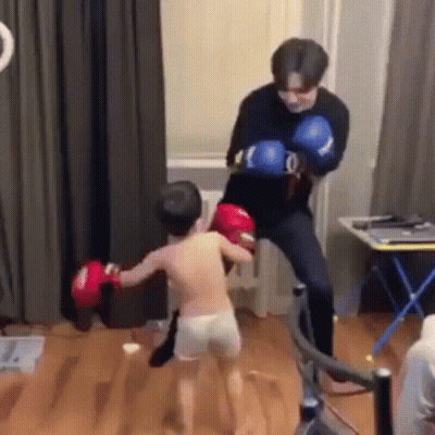 Man Kicking Boy In Face With Boxing Gloves GIF