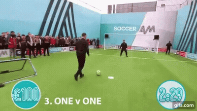 Man Kicking Soccer Ball At Soccer AM Building GIF