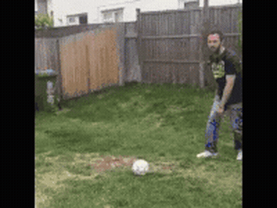 Man Kicking Soccer Ball In Grass GIF