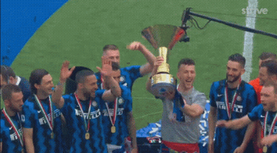 Man Kisses Trophy Surrounded By Soccer Players GIF