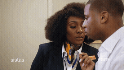Man Kisses Woman By Sistas Sign GIF
