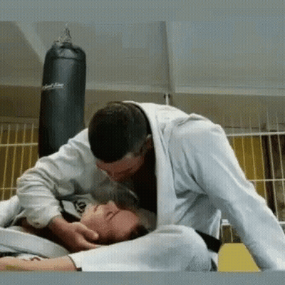 Man Kissing Another Man On Forehead While Wrestling GIF
