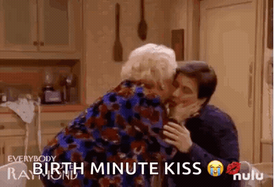 Man Kissing Older Woman On Cheek GIF