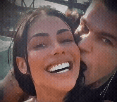 Man Kissing Smiling Woman On Cheek GIF