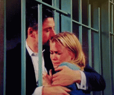 Man Kissing Woman Behind Bars In Jail Cell GIF