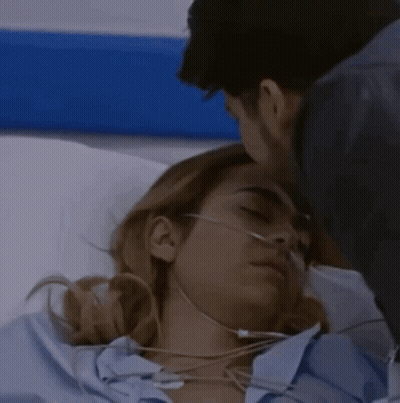 Man Kissing Woman In Hospital Bed With Oxygen Mask GIF