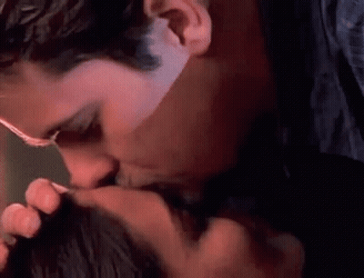 Man Kissing Woman On Cheek GIF