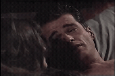 Man Kissing Woman On Cheek In Movie Scene GIF