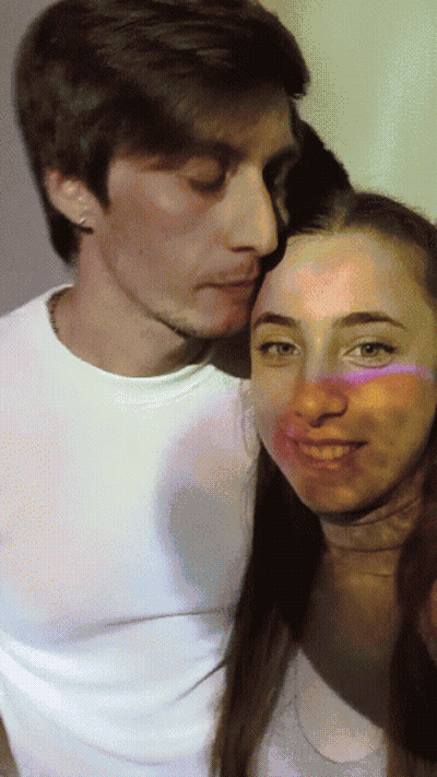 Man Kissing Woman on Cheek While Posing