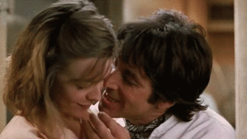 Man Kissing Woman on Forehead