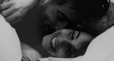 Man Kissing Woman On Forehead In Bed GIF