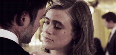 Man Kissing Woman On Forehead In Room GIF
