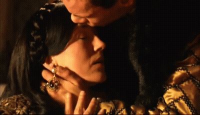Man Kissing Woman On Forehead With Earrings GIF