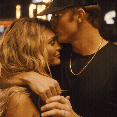 Man Kissing Woman On Forehead With NYC Hat GIF