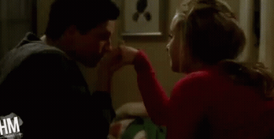 Man Kissing Woman's Hand In Room GIF