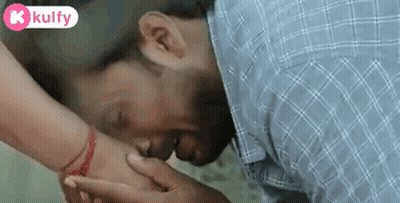 Man Kissing Woman's Hand With Red Bracelet GIF